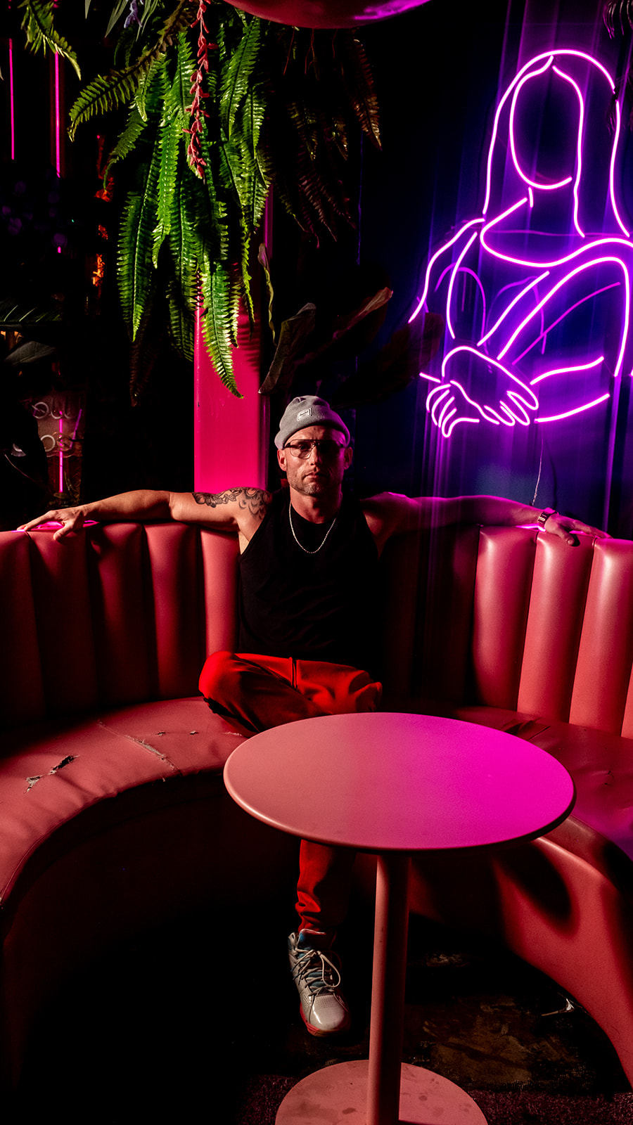 Mr. Burnside seated in a neon-lit Austin venue
